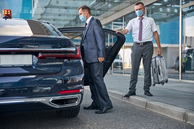 Picture of chauffeur in front of taxi at the airport