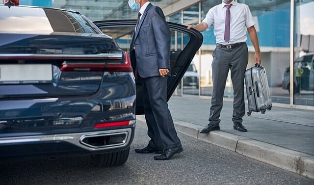 Picture of chauffeur in front of taxi at the airport - Gambia